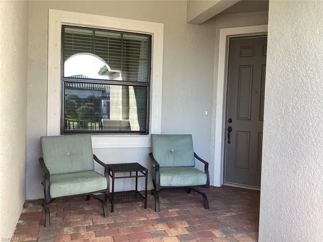 Doorway to property with a patio and stucco siding