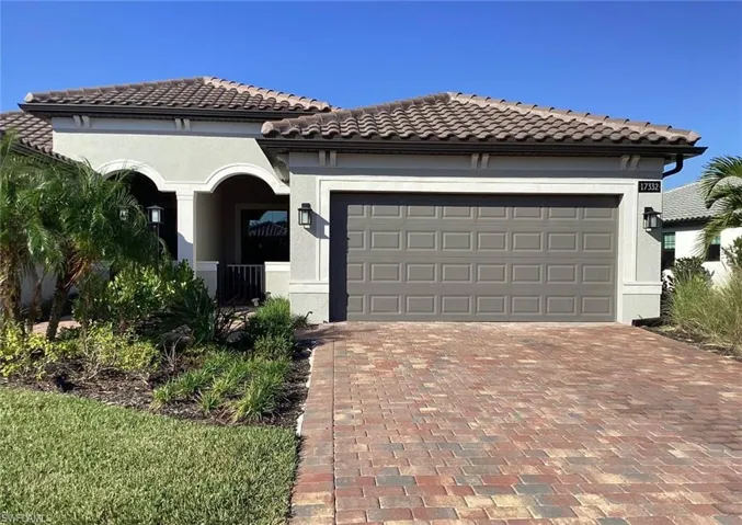 Mediterranean / spanish-style home featuring decorative driveway, stucco siding, and a tile roof