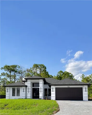 Contemporary exterior with white stucco finish and dark trim accents