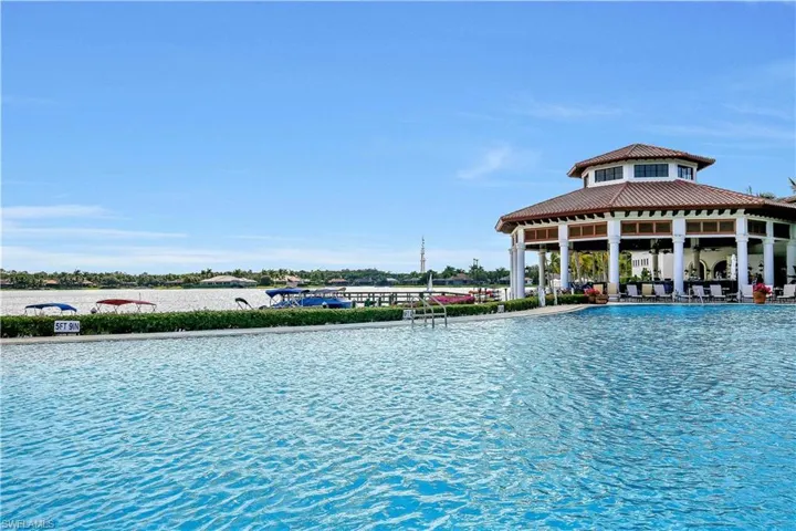 Community pool featuring a patio area, a water view, and a gazebo