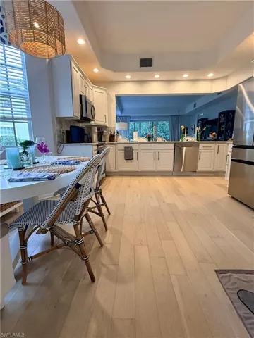 Kitchen with white cabinetry, recessed lighting, appliances with stainless steel finishes, light wood-style flooring, and decorative backsplash