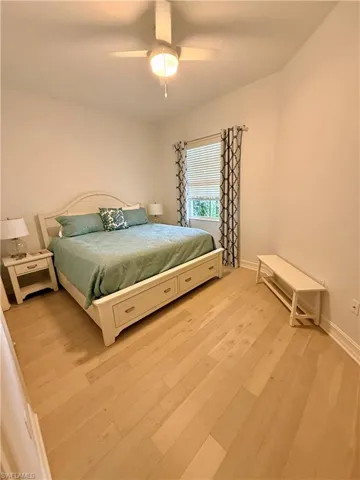 Bedroom featuring ceiling fan and light wood-type flooring