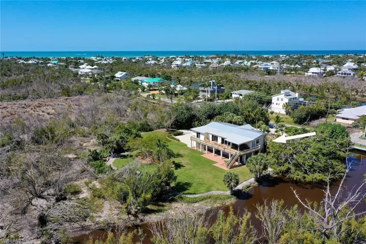 Aerial view of property and surrounding area featuring a large body of water