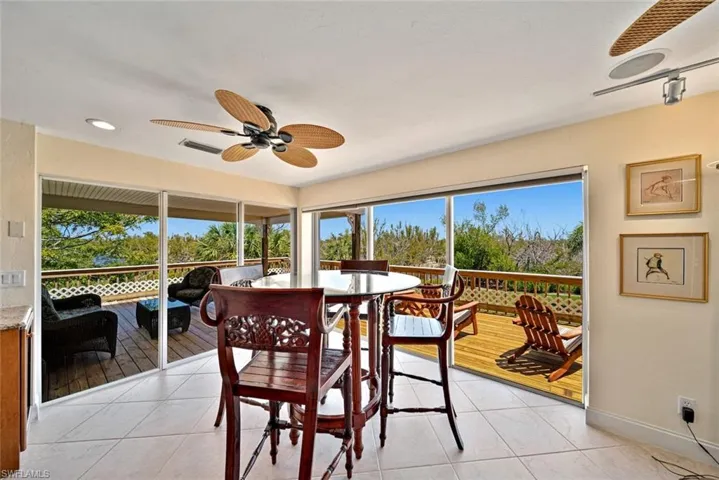 Dining space with a ceiling fan, light tile patterned flooring, and recessed lighting