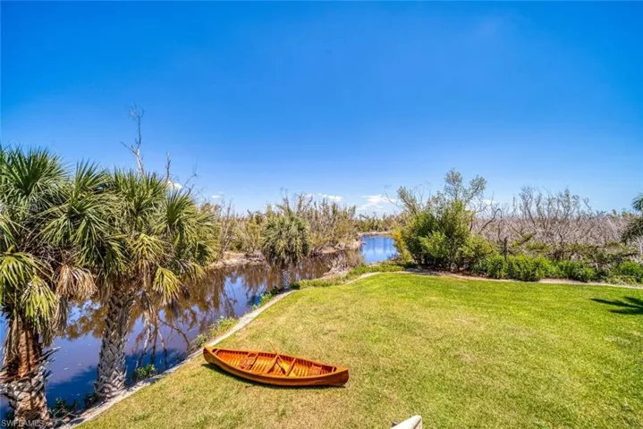 View of grassy yard with a water view