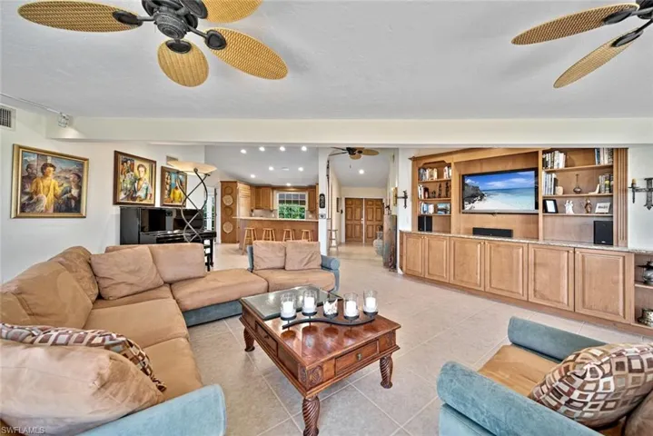 Living room featuring ceiling fan and light tile patterned floors