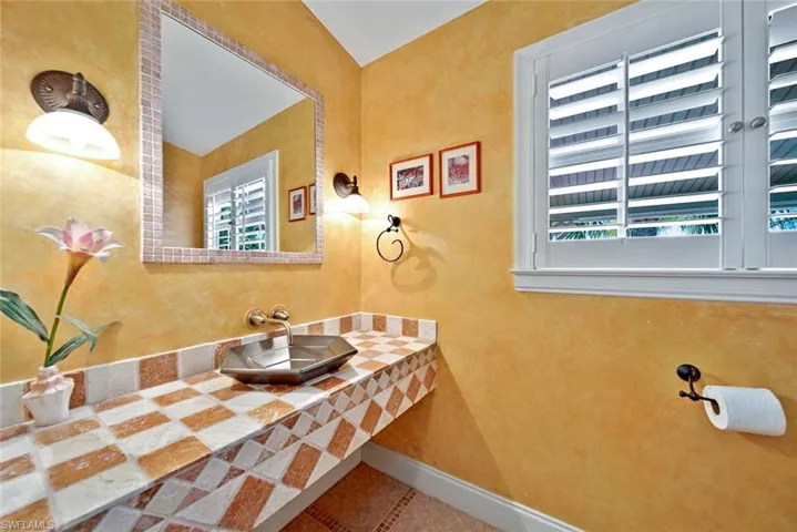 Half bath with vanity and tile patterned floors
