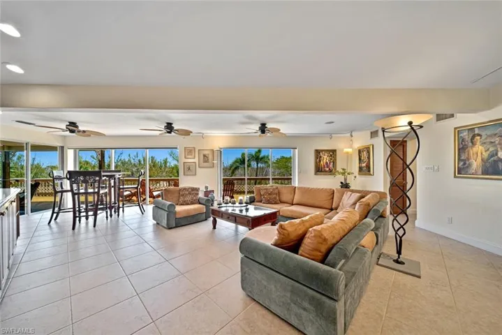 Living room featuring light tile patterned floors and recessed lighting