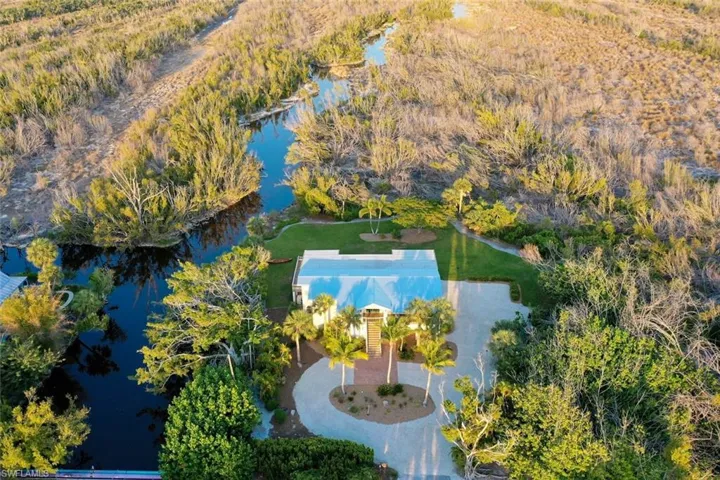 Aerial view of property and surrounding area featuring a large body of water