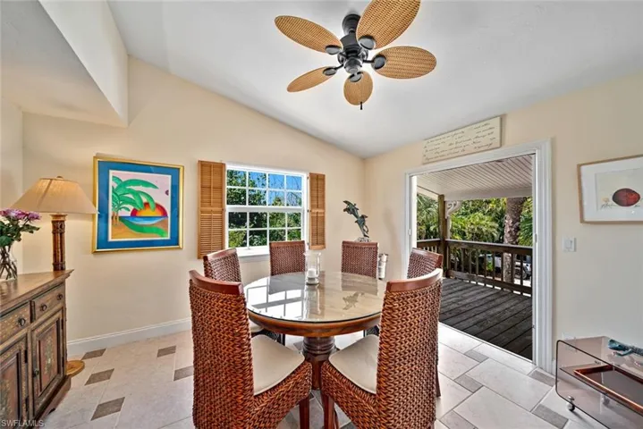 Dining space with vaulted ceiling and a ceiling fan