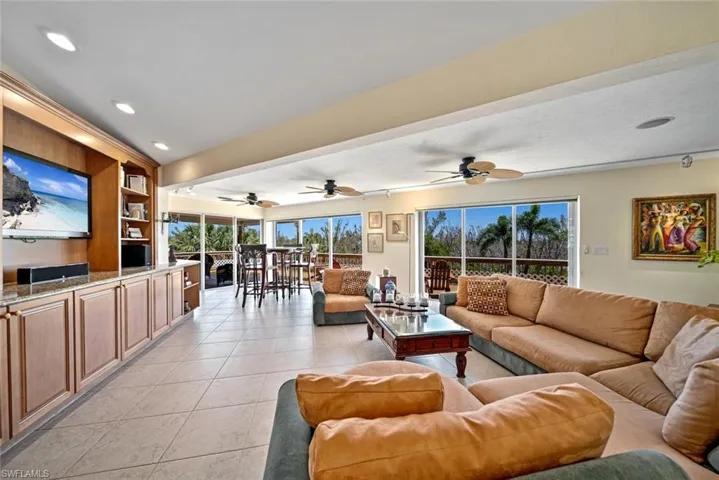 Living room featuring light tile patterned floors, healthy amount of natural light, and recessed lighting