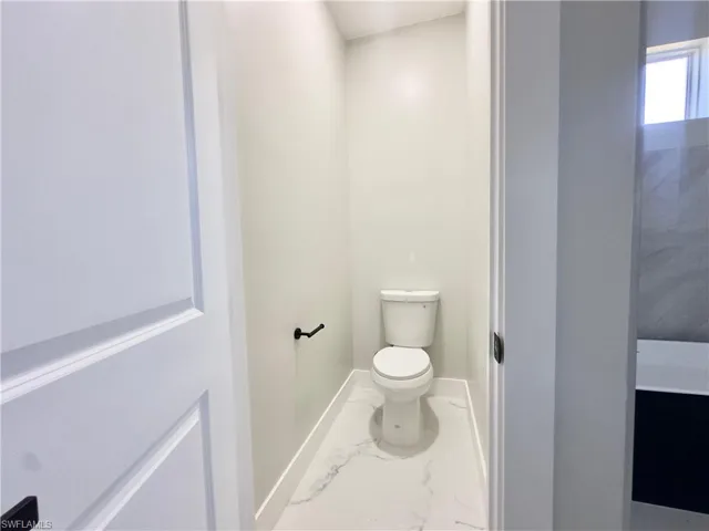 Bathroom with marble finish flooring and baseboards