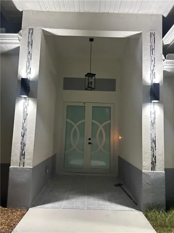 View of exterior entry featuring french doors