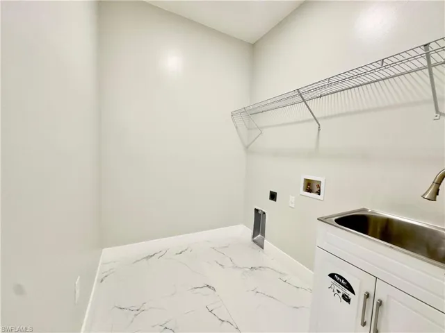Laundry area featuring light marble finish flooring, electric dryer hookup, and hookup for a washing machine