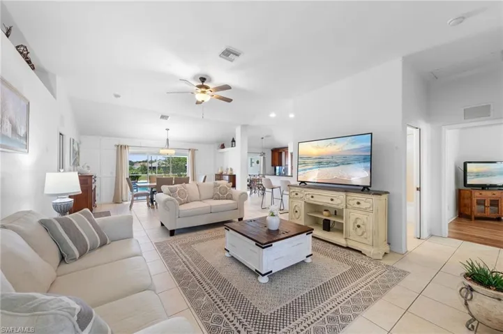 Living area with light tile patterned flooring and a ceiling fan