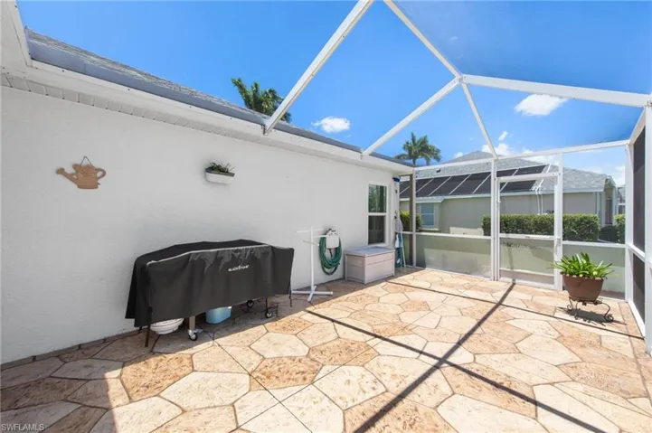 View of patio featuring grilling area and glass enclosure