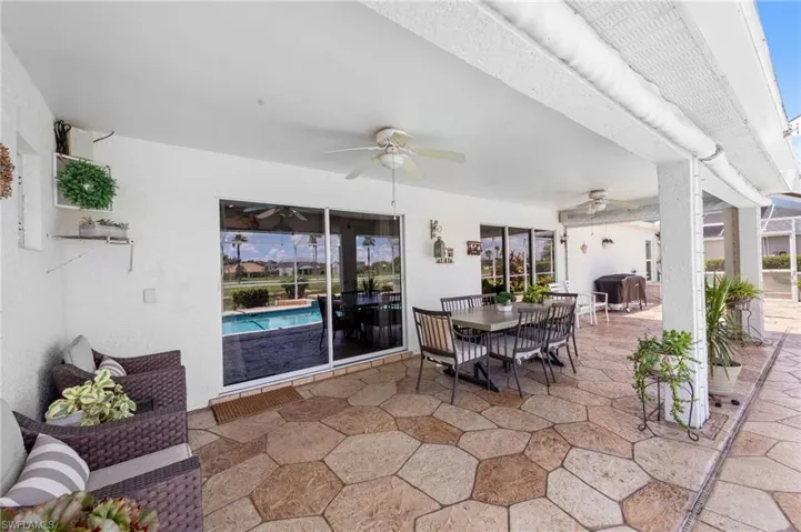 View of patio with a ceiling fan, area for grilling, and outdoor dining area