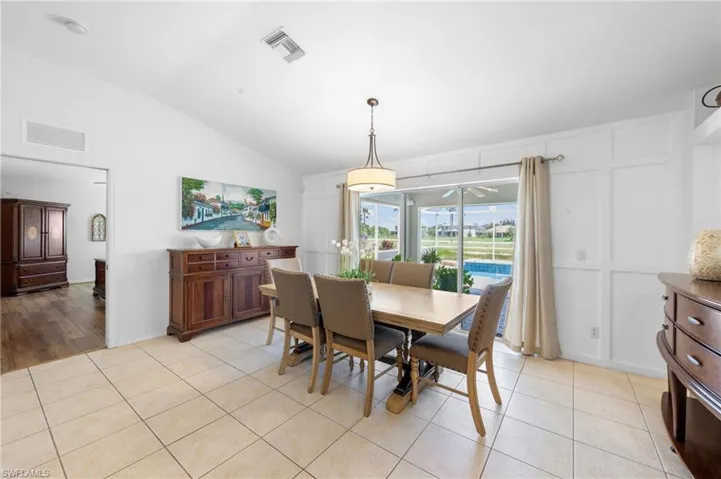 Dining area featuring vaulted ceiling and light tile patterned floors