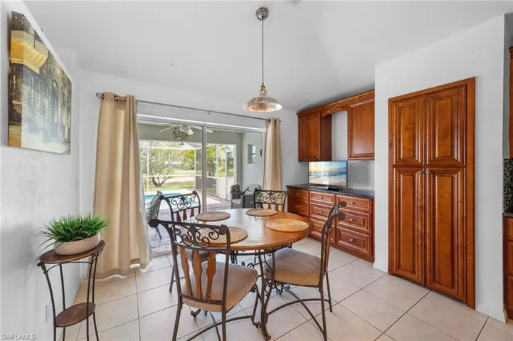 Dining area featuring light tile patterned flooring and ceiling fan
