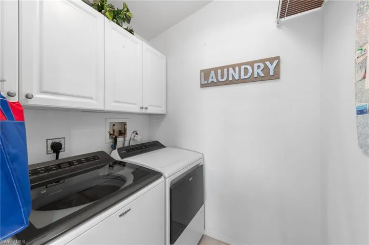 Laundry area featuring cabinet space and washing machine and dryer