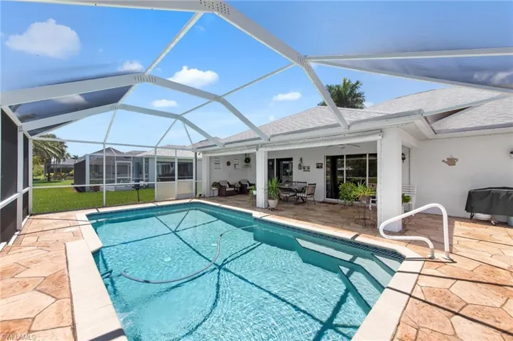 Swimming pool with a patio and a lanai