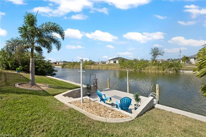 Dock area featuring a water view and a yard