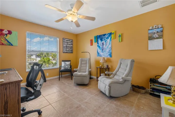 Office with ceiling fan and light tile patterned flooring