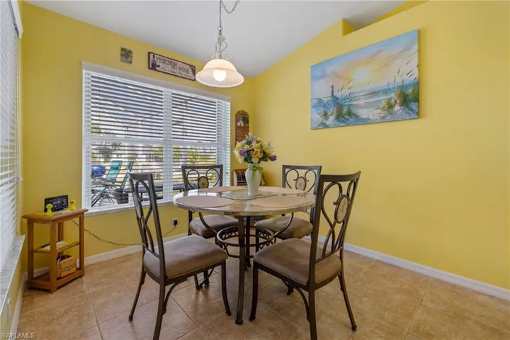 Dining area with light tile patterned floors