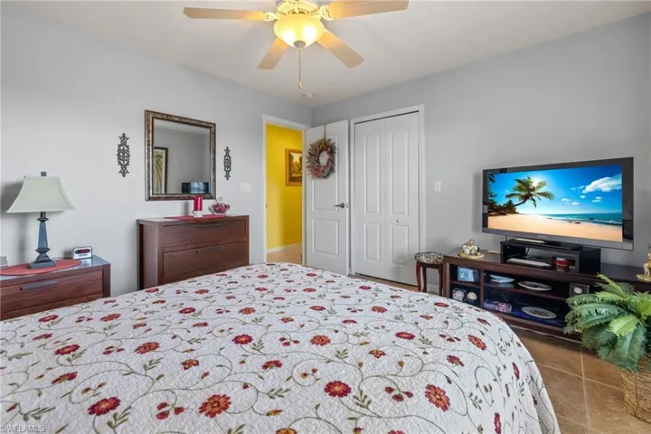 Bedroom with ceiling fan and a closet