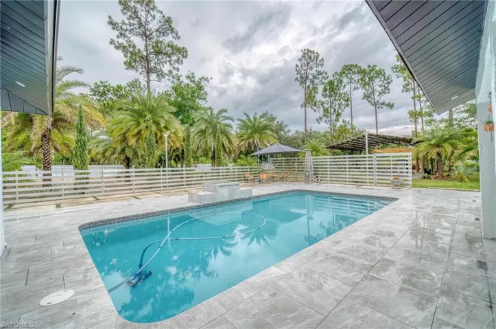 View of pool featuring a fenced backyard and a patio
