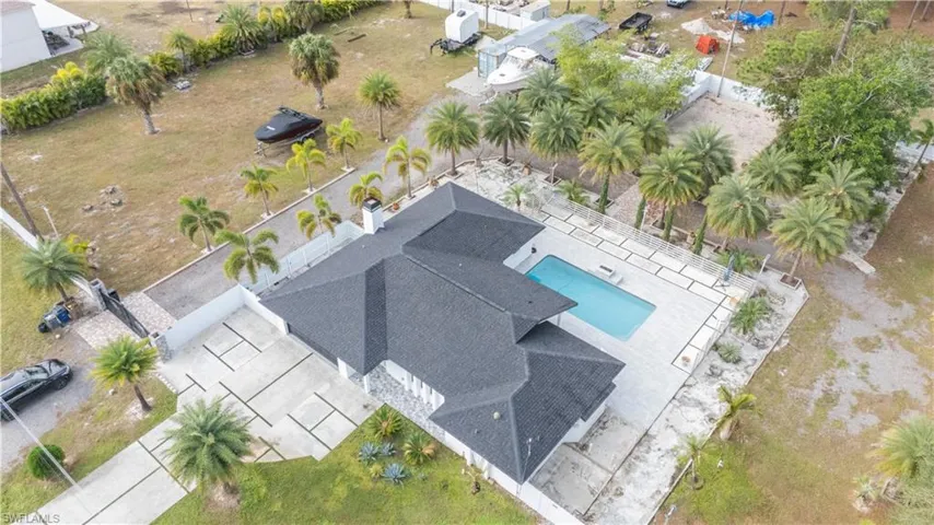 Aerial view of property and surrounding area with a pool
