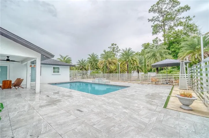 View of pool featuring a patio, a fenced backyard, and ceiling fan