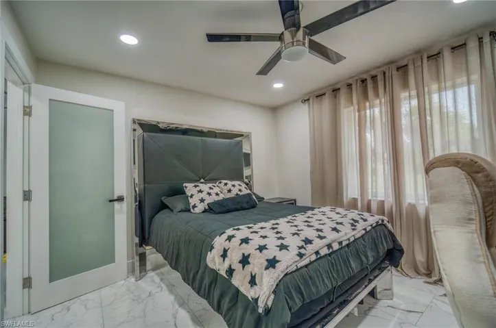 Bedroom featuring light marble finish flooring, recessed lighting, and ceiling fan