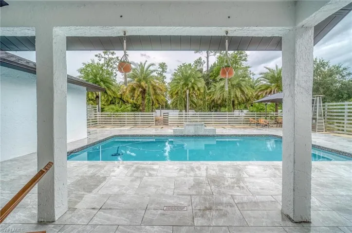 View of swimming pool with a fenced backyard and a patio area
