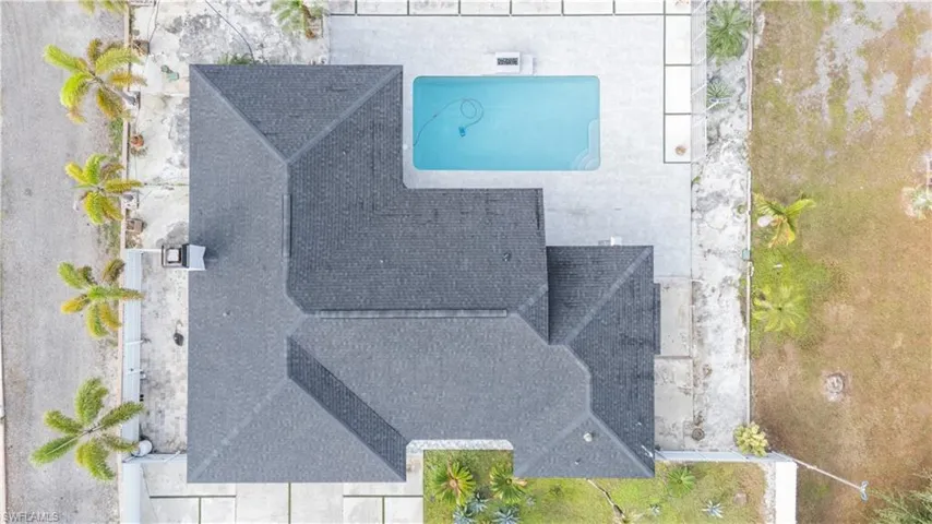 Aerial view of property and surrounding area featuring a pool area