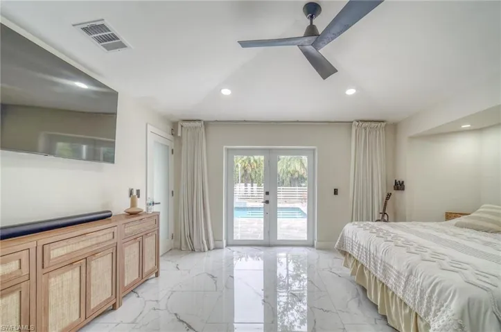 Bedroom with access to exterior, french doors, light marble finish floors, recessed lighting, and ceiling fan