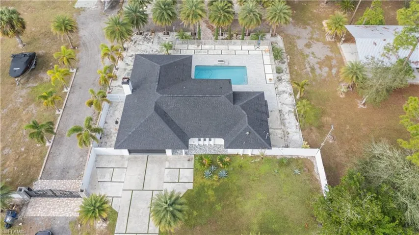 Aerial view of property and surrounding area with a pool area