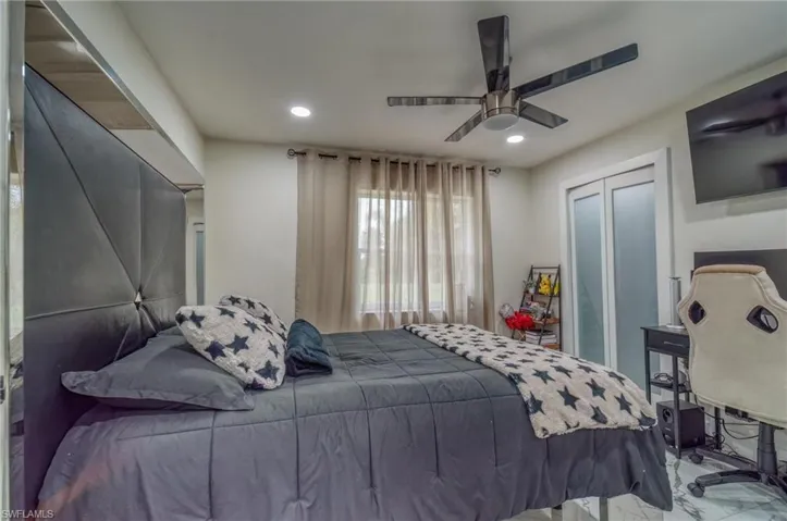 Bedroom with recessed lighting, a closet, ceiling fan, and marble finish floors