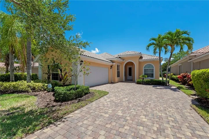 28311 Nautica Lane Bonita Springs FL 34135 - Street view, side entry garage and covered portico at front door