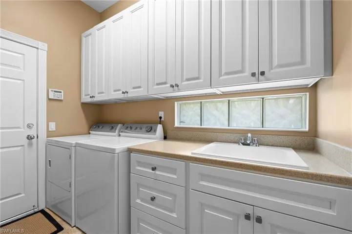 28311 Nautica Lane Bonita Springs FL 34135 - Laundry with utility sink and new cabinets featuring soft close doors & drawers.