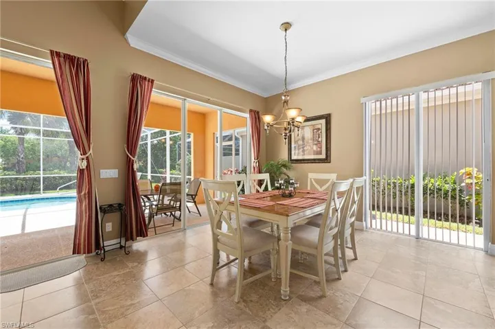 28311 Nautica Lane Bonita Springs FL 34135 - Dining area with view of lake and pool deck