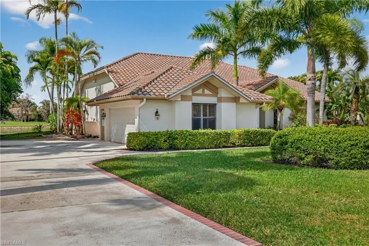 Mediterranean / spanish-style home featuring a front lawn, concrete driveway, stucco siding, an attached garage, and a tiled roof