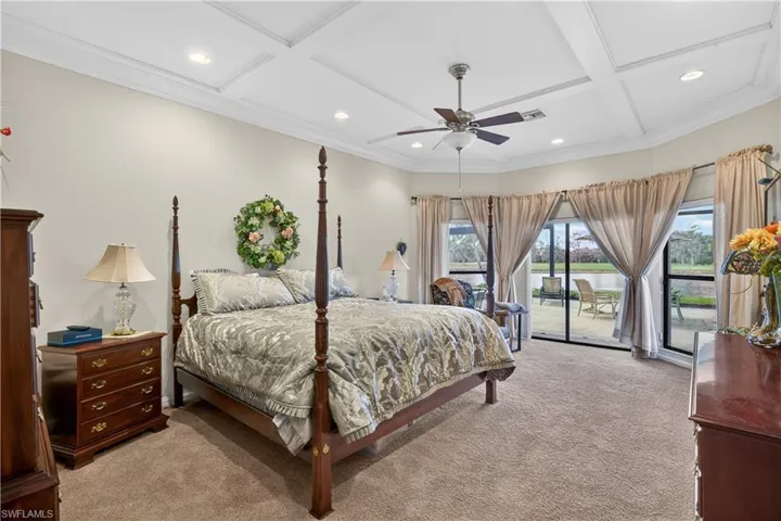 Bedroom with coffered ceiling, access to outside, light carpet, ornamental molding, and a ceiling fan