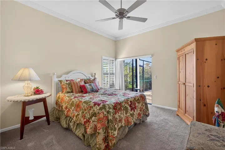 Bedroom featuring access to outside, crown molding, carpet, and a ceiling fan