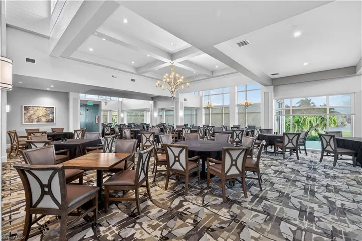 Dining room featuring coffered ceiling and hanging lights