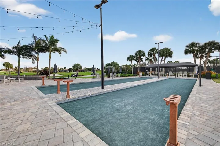 View of swimming pool with a bocce ball area and patio surround