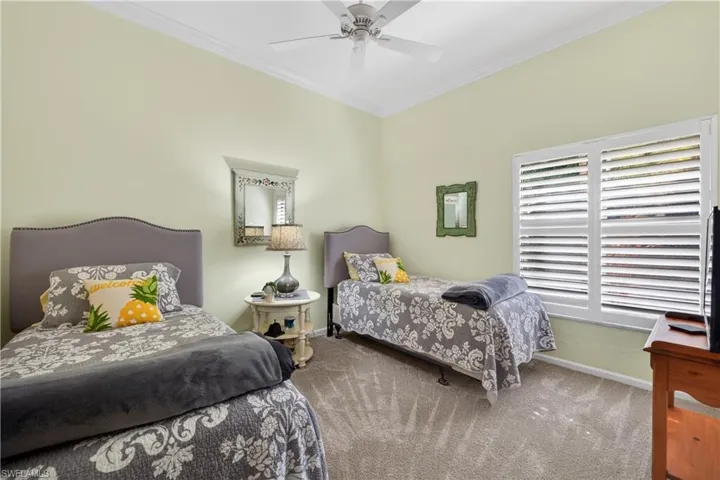 Bedroom featuring crown molding, ceiling fan, and carpet floors