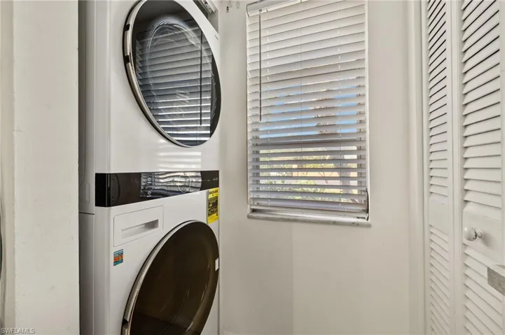 Laundry room with laundry area and stacked washing maching and dryer