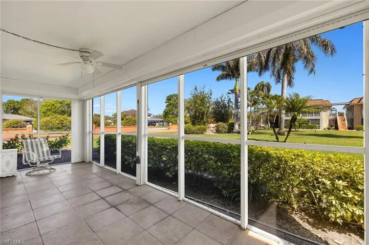 Unfurnished sunroom with ceiling fan