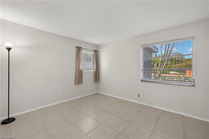 Unfurnished room featuring baseboards and a textured ceiling